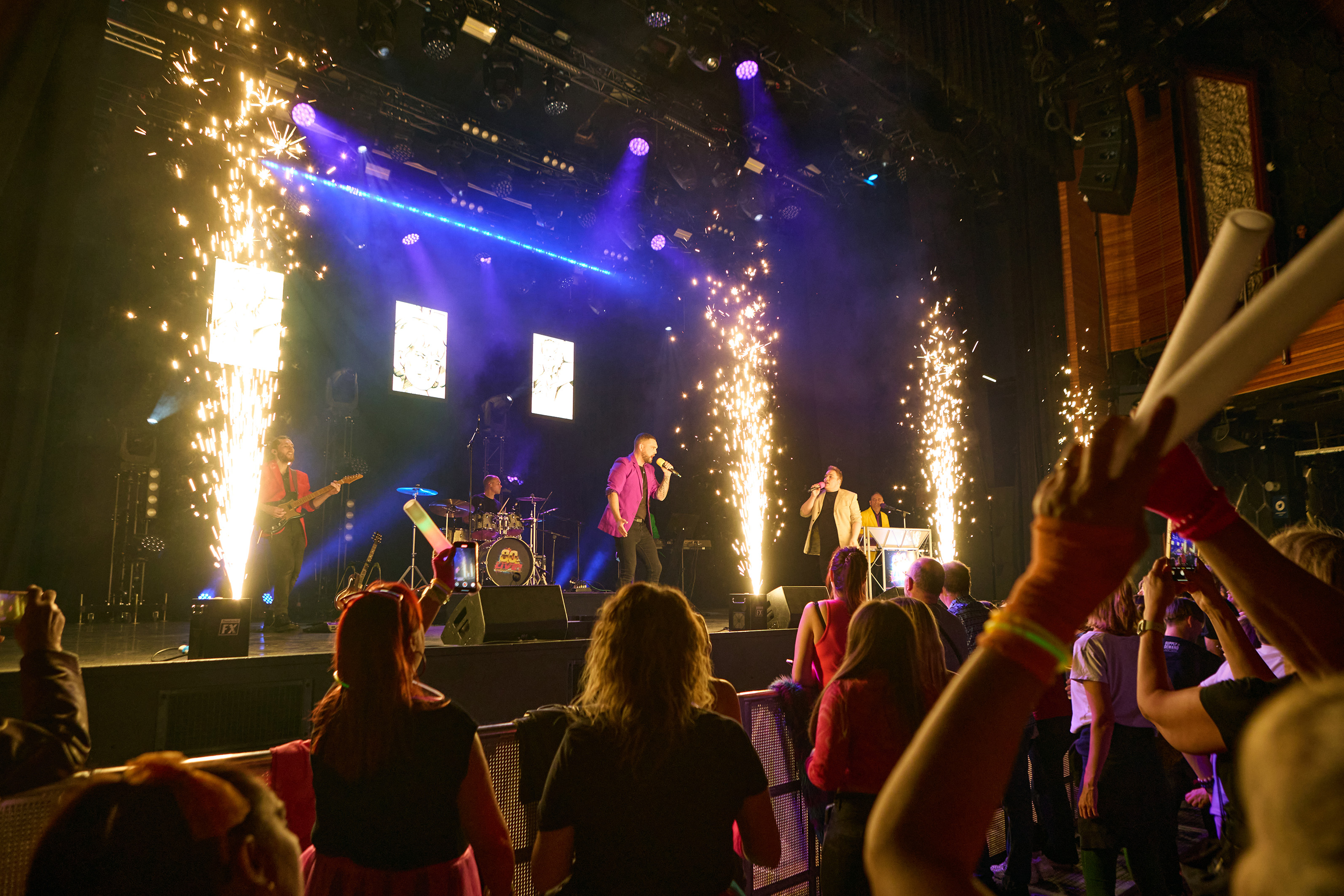 Singers on stage in front of an audience for the theatre show 80s Live coming soon to The Victoria Theatre Halifax
