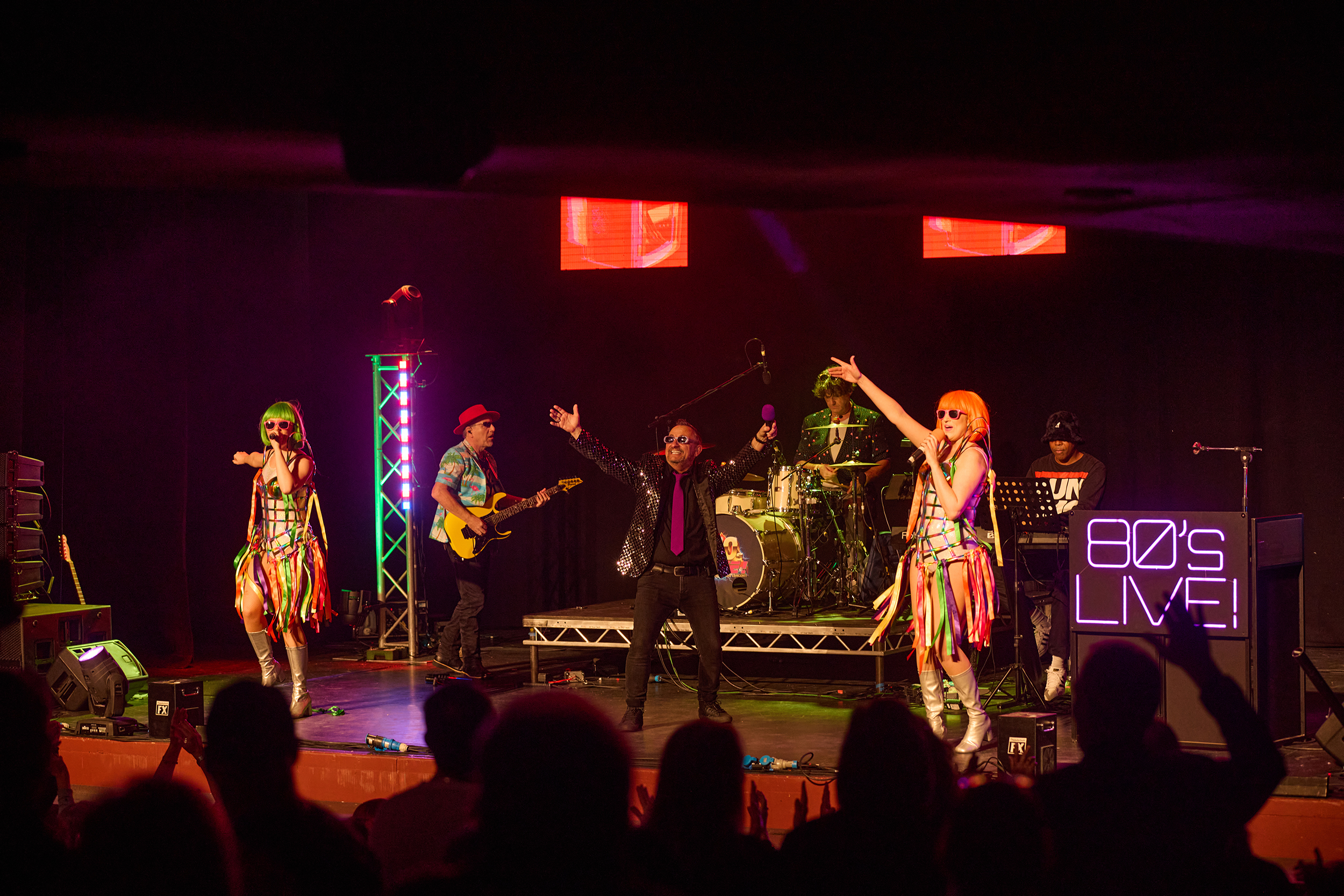 Singers on stage in front of an audience for the theatre show 80s Live coming soon to The Victoria Theatre Halifax