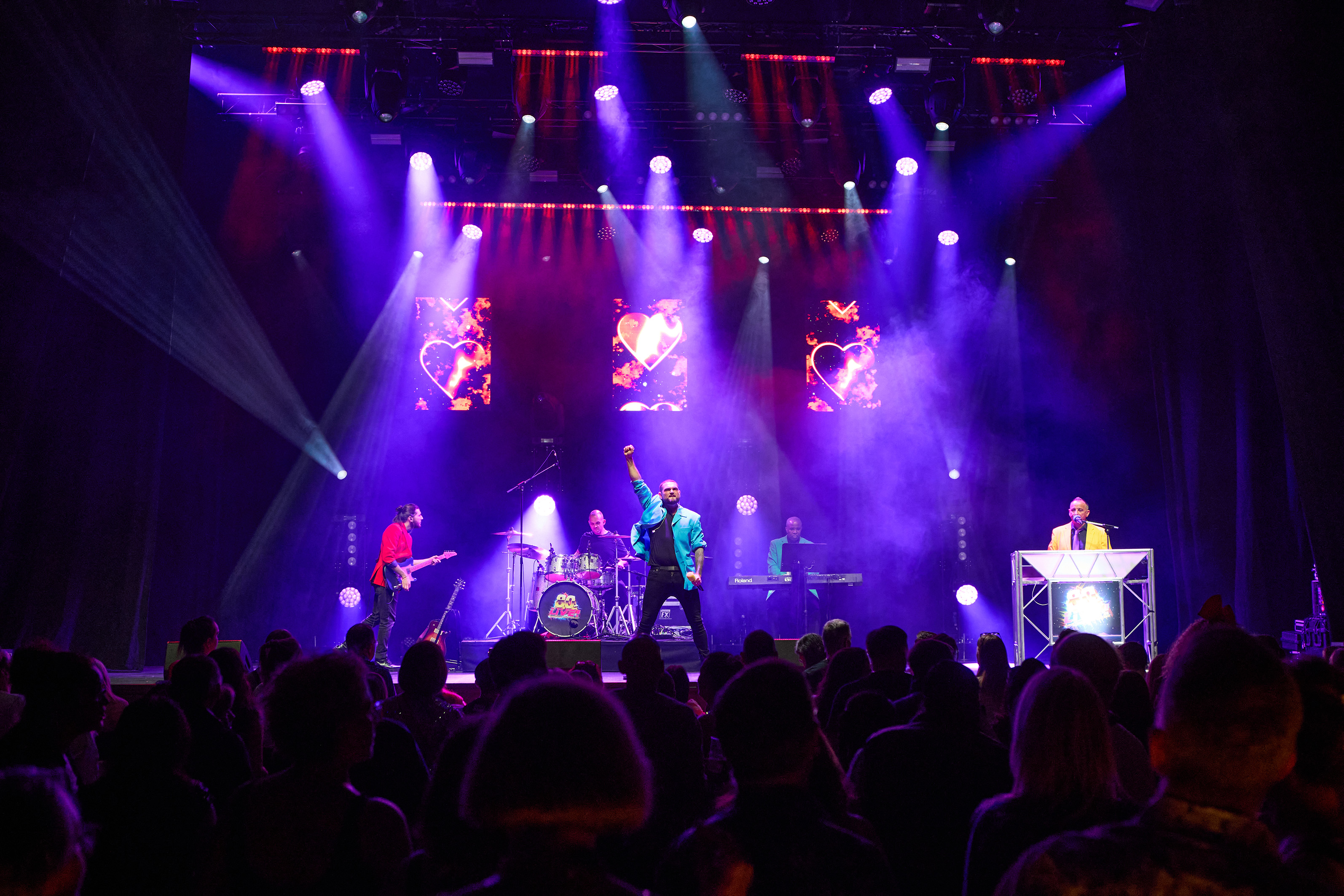 Singers on stage in front of an audience for the theatre show 80s Live coming soon to The Victoria Theatre Halifax