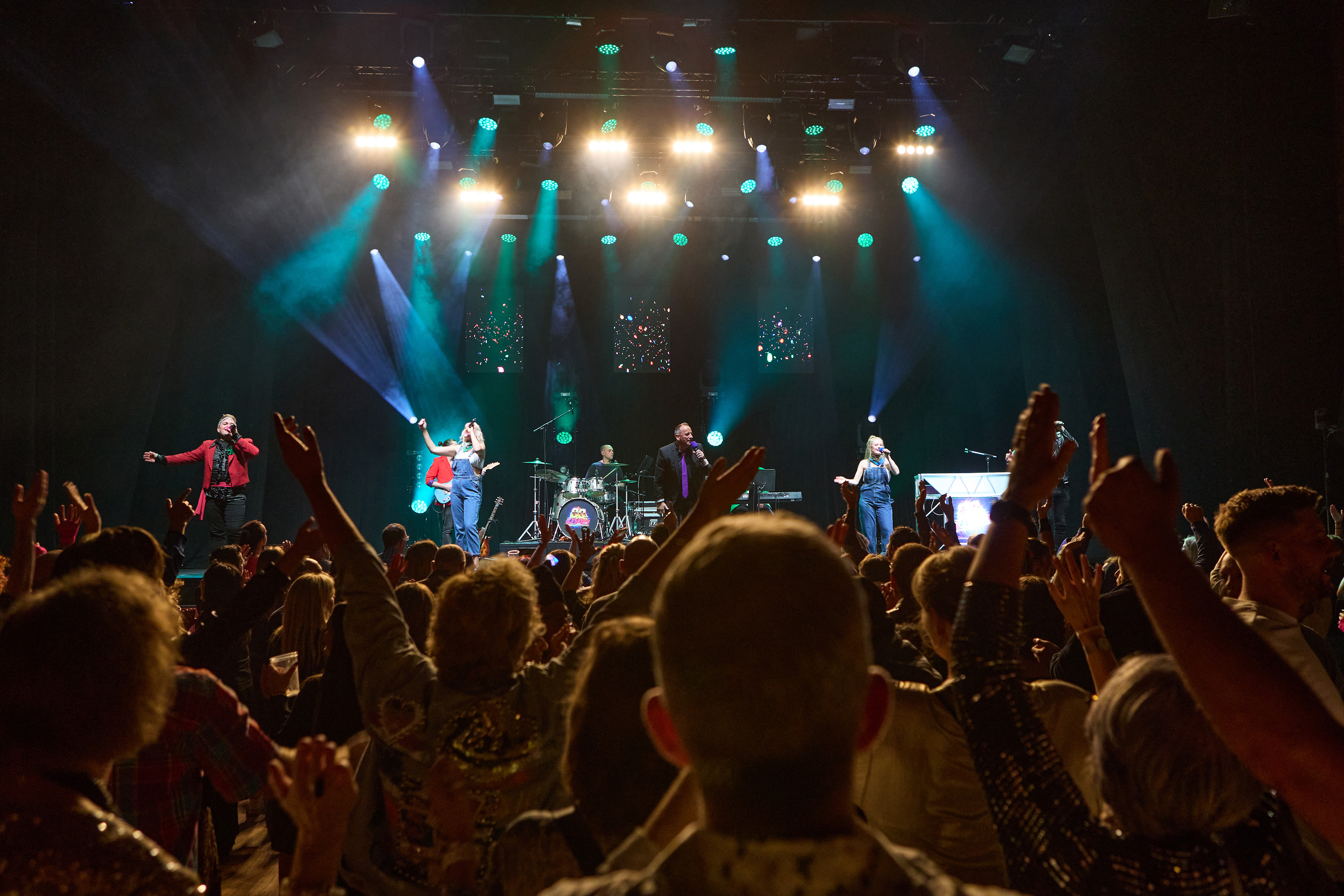 Singers on stage in front of an audience for the theatre show 80s Live coming soon to The Victoria Theatre Halifax
