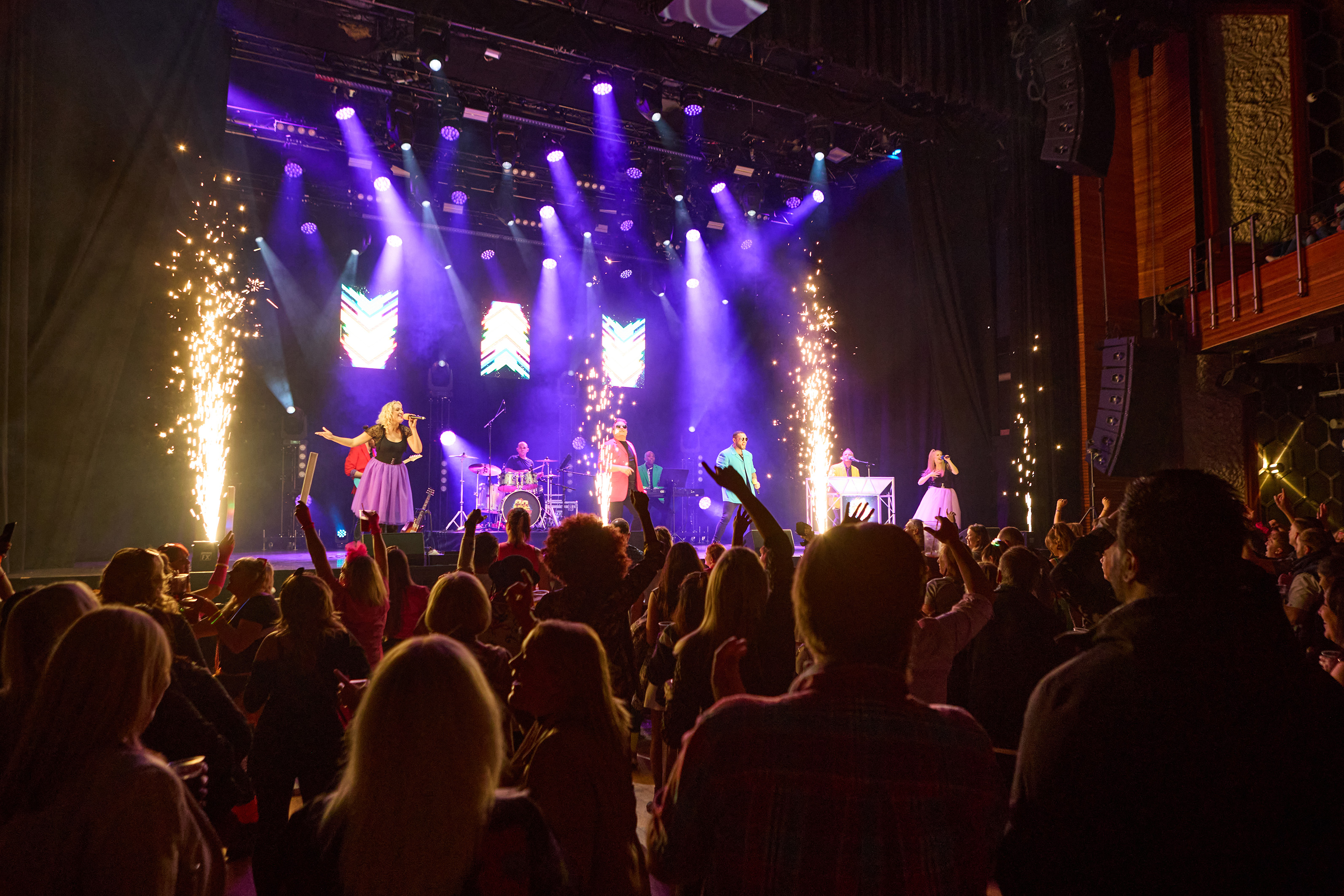 Singers on stage in front of an audience for the theatre show 80s Live coming soon to The Victoria Theatre Halifax