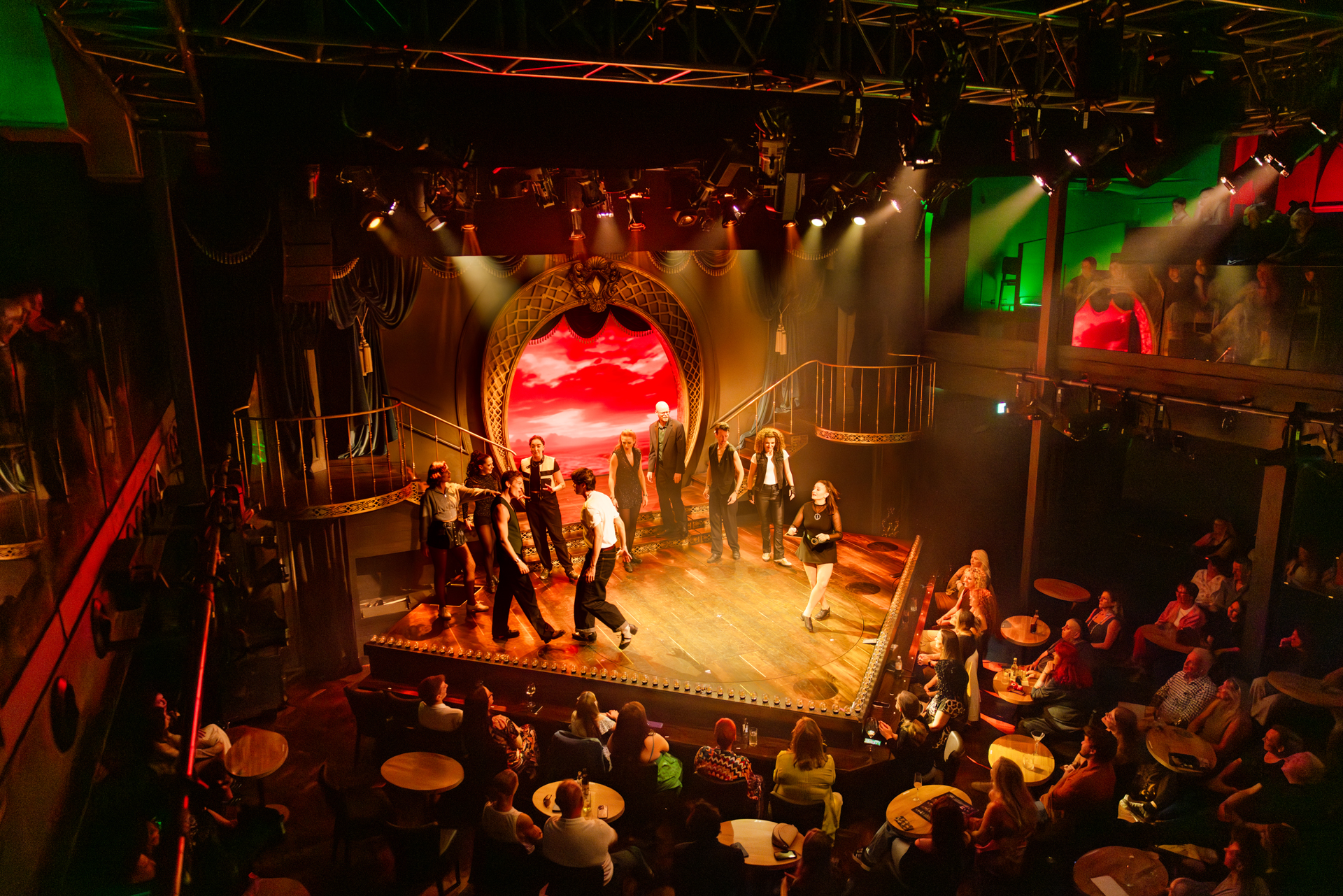 The view of a stage with dancers being watched by an audience for the show Adam Garcia's Emerald Storm