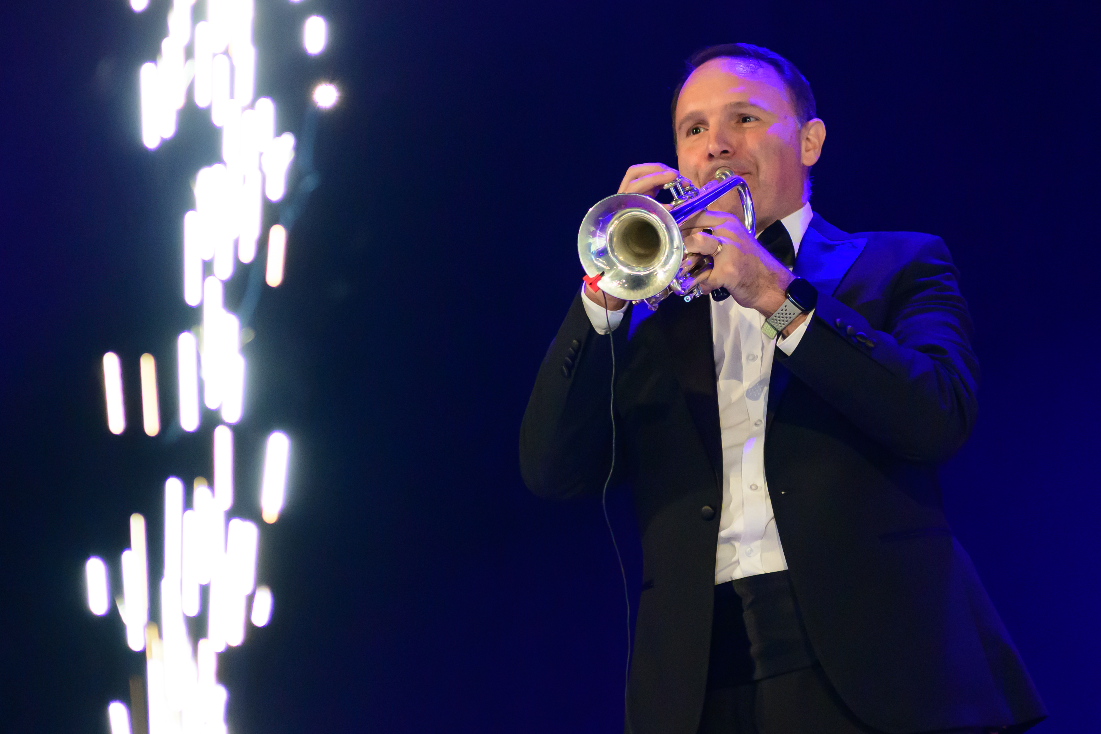 James Bond Themed Concert Spectacular featuring singers and a band on a theatre stage