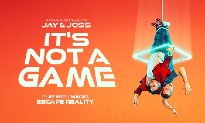 Promotional graphic for Victoria Theatre Halifax show 'It's Not A Game' featuring Britain's Got Talent’s Jay & Joss. The image shows the two men suspended upside down from a single rope, back-to-back, against a vibrant orange background. A glowing neon square frame floats around their waists. The text reads: 'Britain's Got Talent's Jay & Joss: It's Not A Game. Play with Magic. Escape Reality.